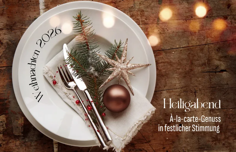 Teller mit Besteck, Weihnachtsstern und Dekoration.
